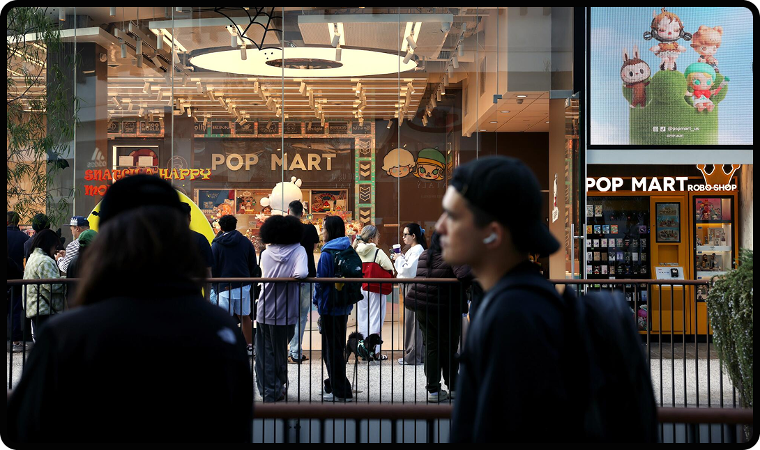 People walking past the storefront of a Pop Mart.